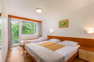 Posteľ alebo postele v izbe v ubytovaní Holiday Resort Kačjak