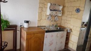 a small kitchen with a sink and a refrigerator at Willa na Skarpie in Oświęcim