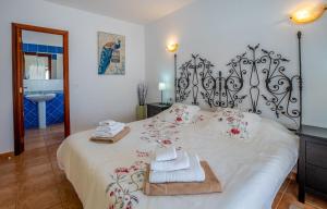 a bedroom with a large bed with towels on it at Villa Iris in Callao Salvaje +39 photos