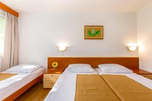 Posteľ alebo postele v izbe v ubytovaní Holiday Resort Kačjak