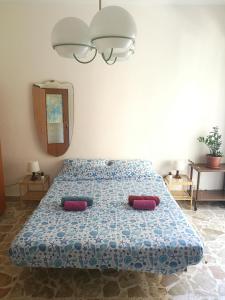 a bedroom with a bed with two pillows on it at At Claudio and Inna's Home in Catania