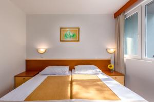 Posteľ alebo postele v izbe v ubytovaní Holiday Resort Kačjak
