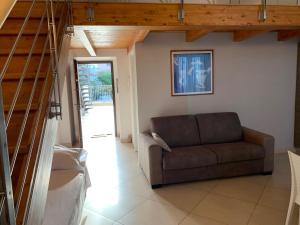 a living room with a couch and a staircase at Hotel Soleluna in Piano di Sorrento