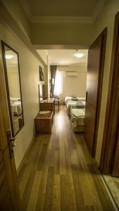 a room with two beds and a mirror and a door at Hotel Cenka Ephesus in Selçuk