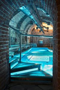 a room with a pool and a stone wall at Hotel Copernicus in Krakow