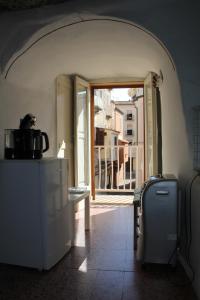 a room with an open door to a balcony at Camera Nella Roccia in Tropea