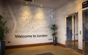 a welcome to london wall mural in a lobby at Thistle London Hyde Park Kensington Gardens in London