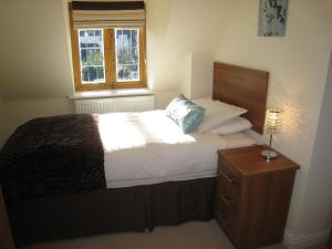 1 dormitorio con cama y ventana en Measure Cottage - Sleeps 5 - Private Hot tub and garden en Henley in Arden