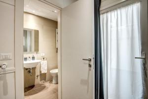 a bathroom with a toilet and a sink at Colosseo Suite Apartment in Rome +7 photos