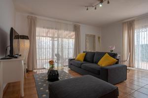 a living room with a couch and a table at Villa Iris in Callao Salvaje