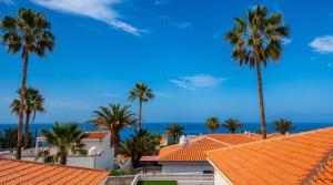 a view of palm trees and buildings with the ocean in the background at Villa Iris in Callao Salvaje