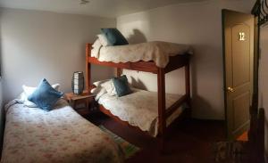 1 Schlafzimmer mit 2 Etagenbetten und 1 Bett in der Unterkunft Hostal Centro Montt in Temuco