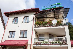 a white building with flowers on the balconies at Goverla in Yaremche