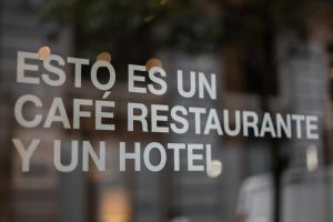a sign on a pole in front of a building at Petit Palace Chueca in Madrid