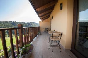 einen Balkon mit Stühlen, einem Tisch und Aussicht in der Unterkunft El Mirador de Bendones in Oviedo