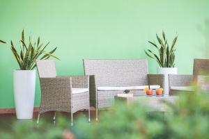 a room with three chairs and a table with plants at Lu' Hotel Porto Pino in SantʼAnna Arresi