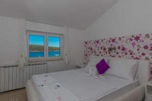 Postel nebo postele na pokoji v ubytování Villa Rossa Apartments