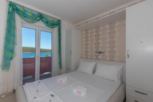 Postel nebo postele na pokoji v ubytování Villa Rossa Apartments
