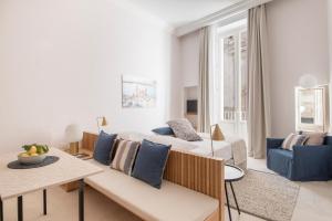 a living room with a bed and a couch at Palazzo Mulini in Monopoli
