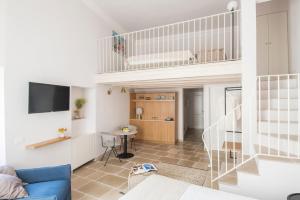 a living room with a blue couch and a staircase at Palazzo Mulini in Monopoli