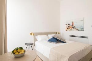 a bedroom with a bed and a bowl of fruit on a table at Palazzo Mulini in Monopoli