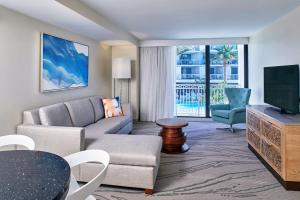 a living room with a couch and a tv at Zota Beach Resort in Longboat Key