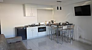 a kitchen with a table and chairs in a room at Carabelli Propiedades II in Río Grande