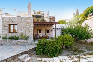 a stone house with a porch and a patio at Villa Maria in Stavrokhórion