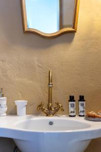 a bathroom sink with a mirror and a white sink at Villa Maria in Stavrokhórion +91 photos