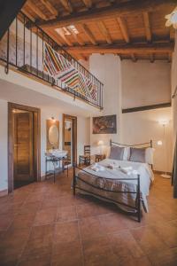 a bedroom with a large bed and a staircase at Residenza Storica le Civette in Castel del Monte