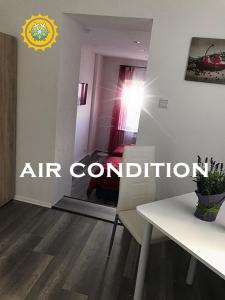 an air conditioned room with a table and a dining room at Appartment am Nordpark in Mönchengladbach