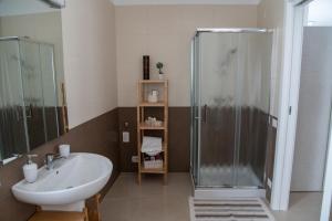 a bathroom with a sink and a shower at CASA VITTORIA in Gravina in Puglia