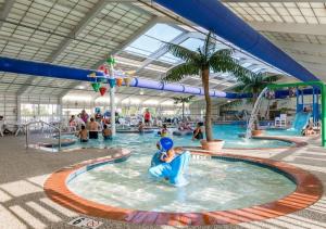 a swimming pool filled with lots of people at Francis Scott Key Family Resort in Ocean City