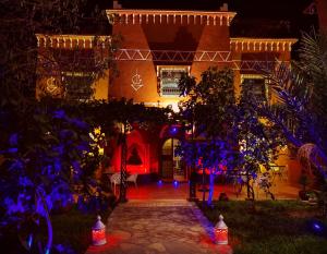 a house with christmas lights in front of it at Riad Chay & Boutique in Ouarzazate