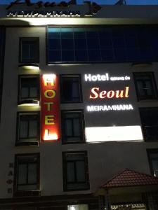 a hotel with a sign on the side of a building at seoul hotel in Shymkent