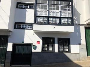 a white and black building with black windows at LOFT RURAL in Tegueste