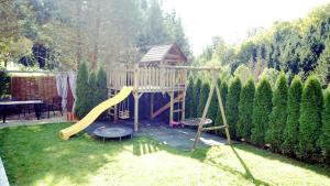 a playground in a yard with a slide at Flamind Holiday Apartments in Altenberg bei Linz
