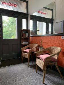 a room with two chairs and a table and a mirror at Manchester Stay Hotel - Free Parking in Manchester