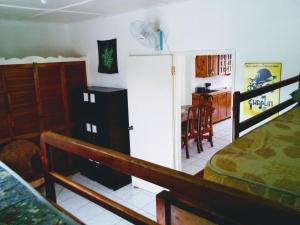 a bedroom with a bed and a dining room at Porty Hostel in Port Antonio