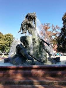 a fountain with a statue of a woman riding a dolphin at Apartamenty Bydgostia in Bydgoszcz