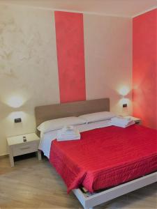 a bedroom with a bed with red and white walls at La Marinella in Palmi +114 photos