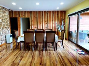 a dining room with a table and chairs at Cabañas el Dorado Pucón in Pucón