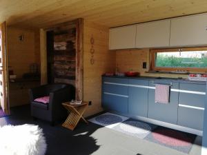 a kitchen with a couch and a chair in a room at forno one in Bürchen