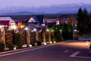 a village at night with a fence and houses at Agroturystyka Piekielnik in Piekielnik