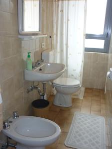 a bathroom with a sink and a toilet at Hotel Milano in Como