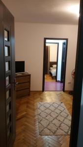 a room with a door leading to a bedroom with a bed at Apartament Lavinia in Călimăneşti