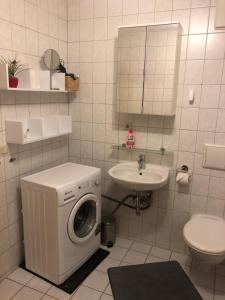 a bathroom with a washing machine and a sink at Apartment 3 Große Brüdergasse in Bautzen +19 photos
