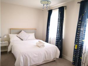 a bedroom with two beds and a window at Reading New Luxury House Wz Garden&Parking by L&S in Reading