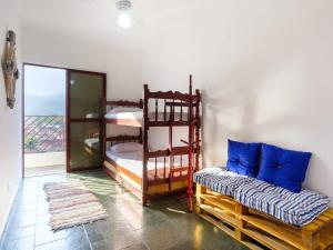 a room with two bunk beds and a couch at Apartamento em Caraguatatuba in Caraguatatuba