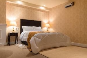 A bed or beds in a room at Hotel Paradis Suite Cusco